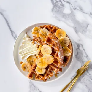 Belgian waffles with caramel, bananas and whipped cream