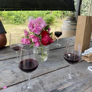 two glasses of wine on a picnic table