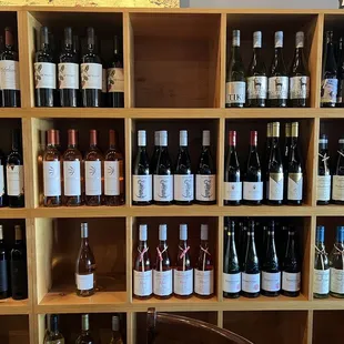 Surrounded by shelves of wine