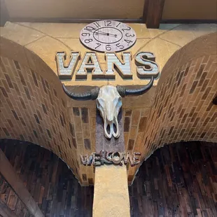 a cow skull mounted on a brick wall
