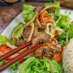 a plate of food and chopsticks