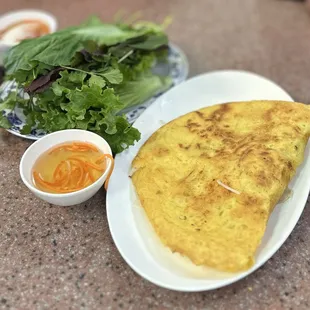 Bánh Xèo: Vietnamese style crepe w/shrimp, pork, bean sprout, mung bean, fish sauce dip, herbs &amp; lettuce/mustard green | $8.95