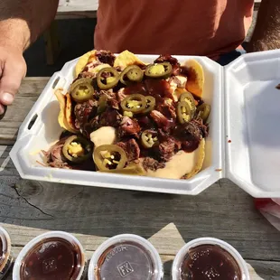 a man holding a tray of food