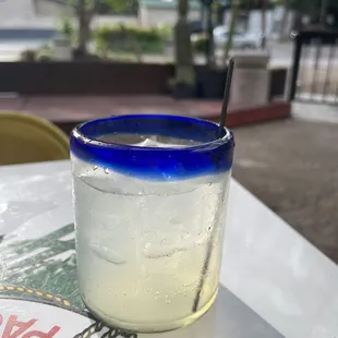 a blue glass with a straw