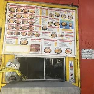 a menu on a yellow door