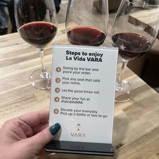 a hand holding a wine glass