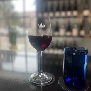 a glass of red wine and a blue glass