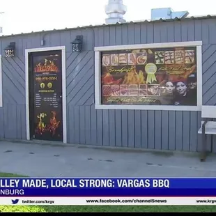 a woman sitting on a bench in front of a building