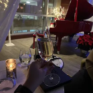 a person sitting at a table with a glass of wine