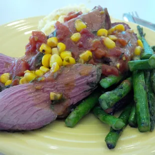 Smoked lamb roast with creamy polenta, asparagus, and heirloom carrots.