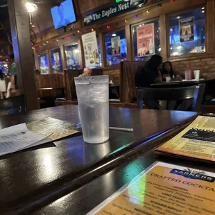 Tables with TVs in the room next to the bar