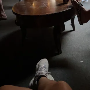 a woman sitting on a table with her legs crossed