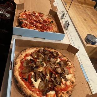 two pizzas in boxes