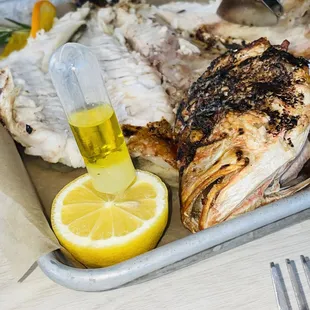 a tray of food with fish and lemon