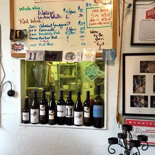 Basic wines written on a dry erase marker board -- tasting plus by the glass options