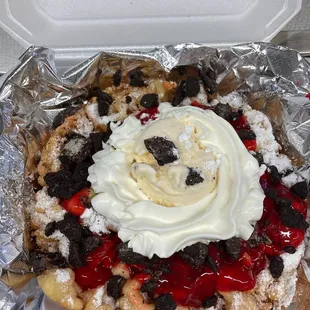 a waffle topped with whipped cream and cherries