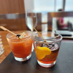 two glasses of cocktail on a table
