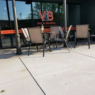 a patio with chairs and tables
