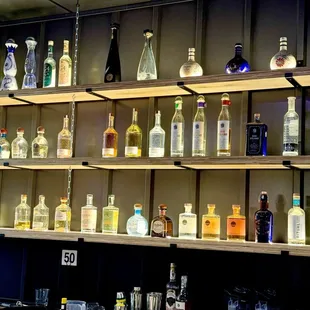 a shelf of liquor bottles