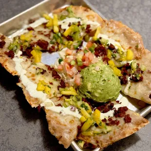 a flatbread pizza with guacamole