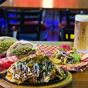 a plate of nachos and a glass of beer