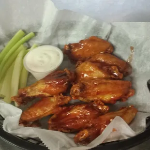 a basket of wings and celery