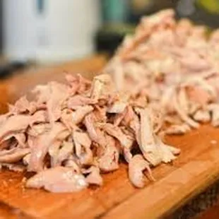 shredded chicken on a cutting board
