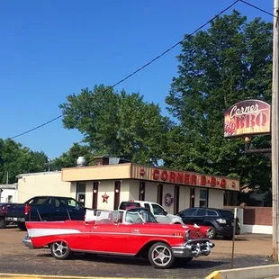 a red car parked in front of a diner
