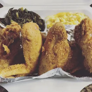 fried fish and vegetables in a styrofoam container