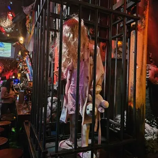 a stuffed animal in a cage