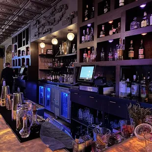 a bar with a lot of bottles and glasses