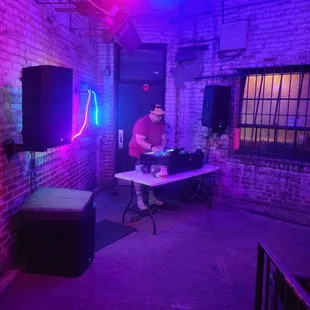 a dj in a dimly lit room