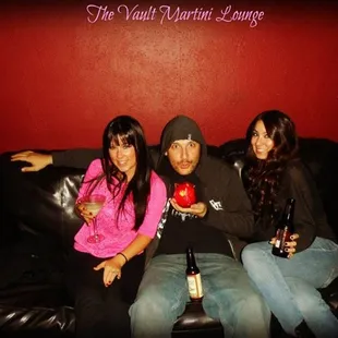 three people sitting on a couch
