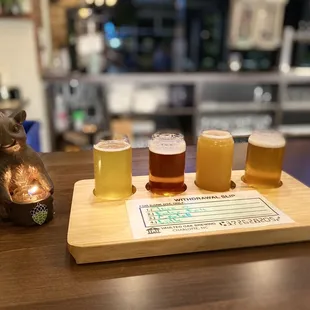 a flight of beers on a serving tray