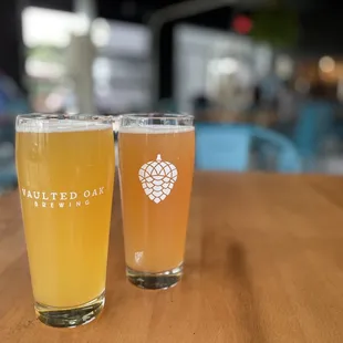two glasses of beer on a table