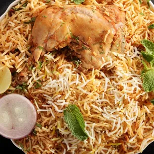 a plate of chicken birya rice