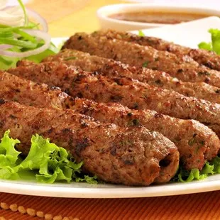 a plate of meat skewers