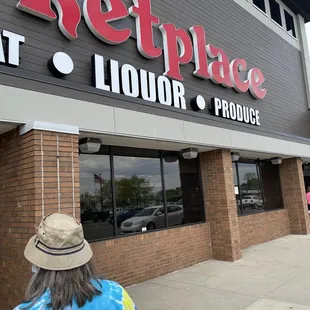 a woman walking in front of the store