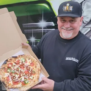 Brian of Lowrider Magazine holding up a Mexican Pizza at the Jan 1st, 2025 Picnic @ William Land Park.