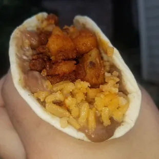 The potatoe and vegan chorizo breakfast taco on flour tortilla with spanish rice and homemade refried beans.