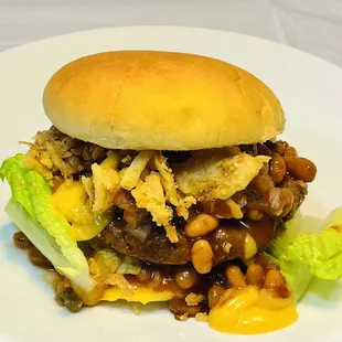 a hamburger with beans, cheese, and lettuce