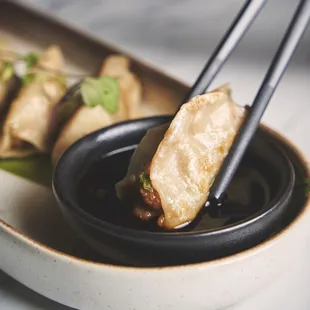 a plate of food with chopsticks