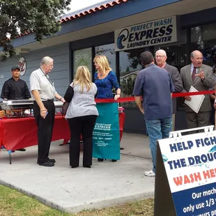 a group of people standing outside of a business
