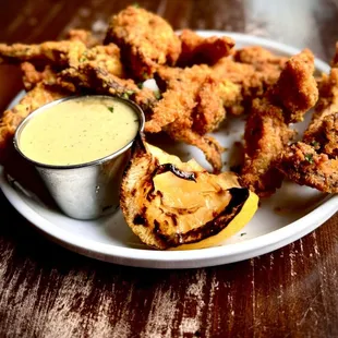 Mushroom Calamari - Oyster mushroom fritters  with smoky herb sauce, seared lemon and parsley.