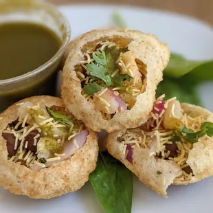 Sev Poori, Round Crispy Puffed Wafers Stuffed With Sprouts, Potatoes, Onion, and chickpeas.