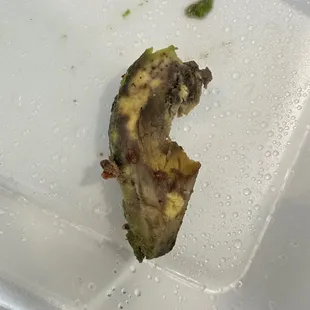 a half eaten banana in a styrofoam container