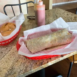 two burritos on a table