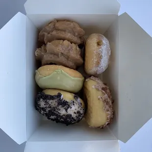 Glazed maple old fashioned, lemon filled, and yeasted matcha, cinnamon, and cookies and cream