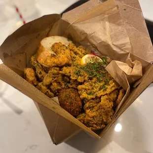 I one of the baskets with oyster mushroom, enoki mushroom, vegan shrimp, a creole ball, fries and toast