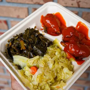 a hand holding a container of food